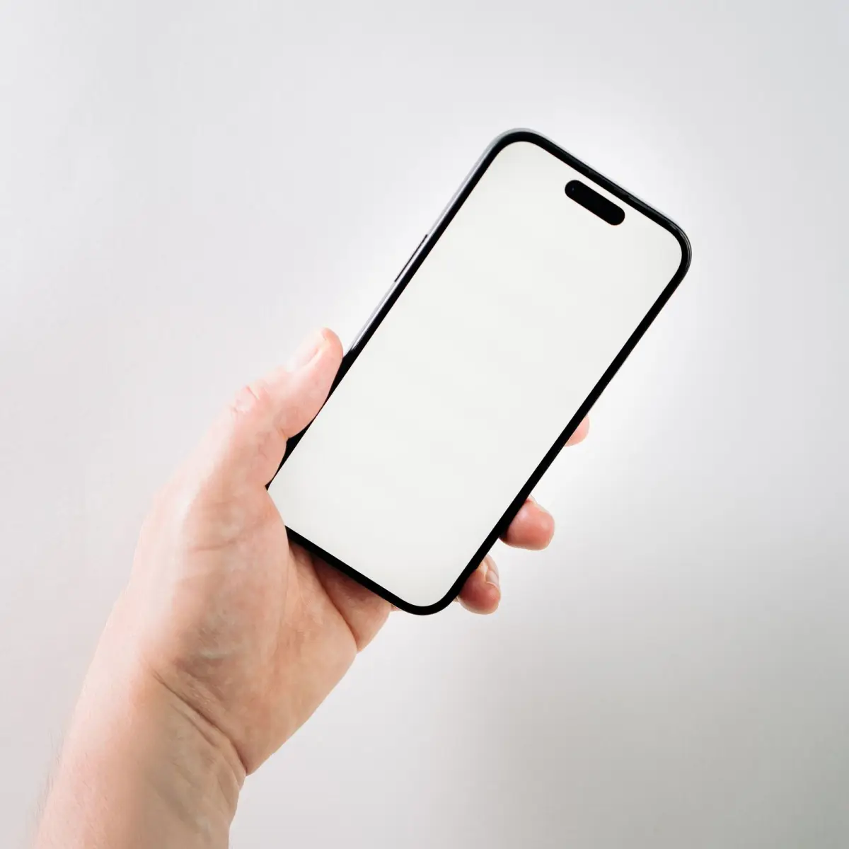A hand holding a smartphone